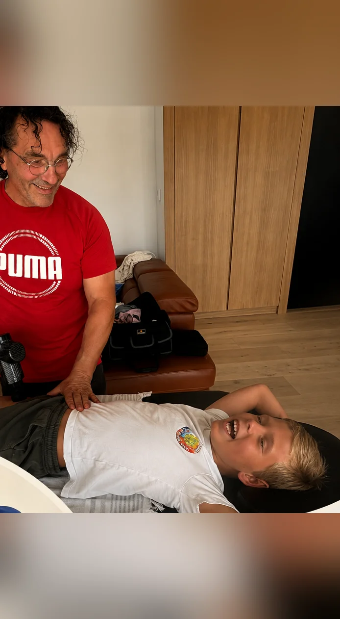 Pasqual treating a young boy who is laughing out loud